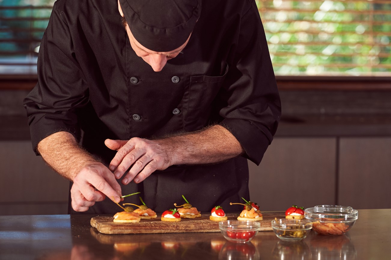 Private chef preparing carefully plated canapés